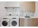 Well-organized laundry room with modern washer and dryer, ample counter space, and storage cabinets at 2425 Peachtree Ne Rd # 1705, Atlanta, GA 30305
