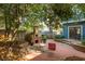 Backyard featuring an outdoor brick oven, mature trees, patio area, and string lights at 243 Sterling St, Decatur, GA 30030