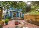 Backyard with a patio, outdoor seating, mature trees, and string lights on a blue house at 243 Sterling St, Decatur, GA 30030