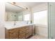 Bathroom features a modern vanity with dual sinks, a large mirror, and a glass-enclosed shower at 243 Sterling St, Decatur, GA 30030