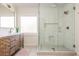 Bathroom featuring a glass shower with tiled walls, a modern vanity, and a window at 243 Sterling St, Decatur, GA 30030