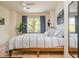 Bedroom with natural light, hardwood floors, and a comfortable bed with striped bedding at 243 Sterling St, Decatur, GA 30030