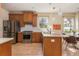 Bright kitchen with stainless steel appliances, wood cabinets, island, and eat-in breakfast nook at 243 Sterling St, Decatur, GA 30030