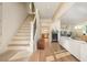 Bright living room featuring hardwood floors, a staircase, and access to other rooms at 243 Sterling St, Decatur, GA 30030