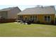 A spacious backyard featuring a patio and green lawn at 5250 Fieldgate Ridge Dr, Cumming, GA 30028