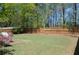 Backyard featuring a patio, a green lawn, and a wooden fence at 5250 Fieldgate Ridge Dr, Cumming, GA 30028