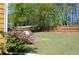 Beautifully landscaped backyard with green lawn, patio, and a full wooden fence at 5250 Fieldgate Ridge Dr, Cumming, GA 30028