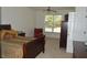Relaxing bedroom featuring a cozy bed, dresser, ceiling fan, and a sunlit window at 5250 Fieldgate Ridge Dr, Cumming, GA 30028