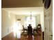 Bright dining room features a round glass table with seating for six and a decorative chandelier at 5250 Fieldgate Ridge Dr, Cumming, GA 30028