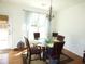 Inviting dining room with a glass-top table, six chairs, and natural light, great for Gathering gatherings at 5250 Fieldgate Ridge Dr, Cumming, GA 30028