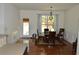Elegant dining room featuring hardwood floors, a chandelier, and access to the backyard at 5250 Fieldgate Ridge Dr, Cumming, GA 30028