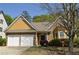 Charming home featuring stone and shingle accents, well-manicured landscaping, and an attached two-car garage at 5250 Fieldgate Ridge Dr, Cumming, GA 30028