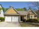Charming home featuring stone and shingle accents, well-manicured landscaping, and an attached two-car garage at 5250 Fieldgate Ridge Dr, Cumming, GA 30028