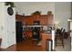 Open kitchen with dark cabinets, stainless steel appliances, and a view of the living area at 5250 Fieldgate Ridge Dr, Cumming, GA 30028