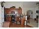 Well-equipped kitchen features wooden cabinets, stainless steel appliances, and a breakfast bar at 5250 Fieldgate Ridge Dr, Cumming, GA 30028