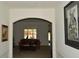 An arched entryway leads into a naturally lit living room with warm colored furniture and carpet flooring at 5250 Fieldgate Ridge Dr, Cumming, GA 30028