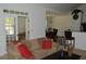 Comfortable living room featuring a plush sofa, red throw pillows, and views into the dining room at 5250 Fieldgate Ridge Dr, Cumming, GA 30028