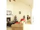 Cozy living room features a fireplace, vaulted ceilings, and seamless flow to other rooms at 5250 Fieldgate Ridge Dr, Cumming, GA 30028
