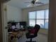 Functional home office with natural light, equipped with a desk, computer, and ample storage at 5250 Fieldgate Ridge Dr, Cumming, GA 30028