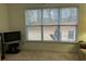 Cozy sitting area with a large window, television, and comfortable seating arrangement at 5250 Fieldgate Ridge Dr, Cumming, GA 30028
