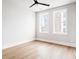 Bright bedroom featuring hardwood floors, ceiling fan and dual windows with views at 7230 Summit Pl, Alpharetta, GA 30009