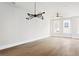 Spacious living room with modern lighting and hardwood floors throughout at 7230 Summit Pl, Alpharetta, GA 30009