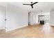 Open concept living area with hardwood floors, modern lighting, and an eat-in kitchen at 7230 Summit Pl, Alpharetta, GA 30009