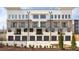 Rear view of townhomes with attached garages and balconies on multiple levels at 7230 Summit Pl, Alpharetta, GA 30009