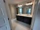 Bathroom features a double vanity with undermount sinks and a large framed mirror at 255 Depot Landing Rd # 38, Auburn, GA 30011