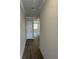 Hallway with wood-look flooring and white trim, leading to the living areas at 255 Depot Landing Rd # 38, Auburn, GA 30011