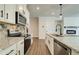 Modern kitchen featuring granite countertops, stainless steel appliances, and stylish cabinets with matte black hardware at 255 Depot Landing Rd # 38, Auburn, GA 30011