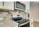 Close-up of the kitchen showcasing granite countertops, stainless steel appliances and decorative tile backsplash at 255 Depot Landing Rd # 38, Auburn, GA 30011