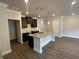 Open kitchen with a large island, granite countertops, and dark wood cabinets at 255 Depot Landing Rd # 38, Auburn, GA 30011