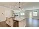 Kitchen island with granite countertop, undermount sink, black faucet and stainless steel dishwasher at 255 Depot Landing Rd # 38, Auburn, GA 30011