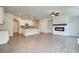Open-concept living area with fireplace, modern floors, and a kitchen view at 255 Depot Landing Rd # 38, Auburn, GA 30011