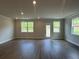 Open living room featuring recessed lighting, hardwood floors, and windows with views to the yard at 255 Depot Landing Rd # 38, Auburn, GA 30011