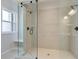 Modern bathroom with glass shower enclosure, tiled walls, built-in bench, and sleek hardware at 255 Depot Landing Rd # 38, Auburn, GA 30011