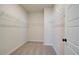 Spacious walk-in closet with wire shelving and neutral carpet at 255 Depot Landing Rd # 38, Auburn, GA 30011