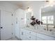 Bathroom featuring double sinks, elegant fixtures, and a bright window at 3395 Lee St, East Point, GA 30344
