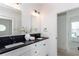 Bathroom with and sinks, two mirrors and black marble countertops at 3395 Lee St, East Point, GA 30344