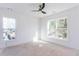 Bright bedroom featuring a modern ceiling fan and two large windows at 3395 Lee St, East Point, GA 30344