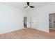 Bright bedroom featuring hardwood floors and multiple entry doors to closet, bathroom, and hallway at 3395 Lee St, East Point, GA 30344
