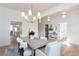 Bright dining room with modern chandelier, light walls, and wood floors at 3395 Lee St, East Point, GA 30344