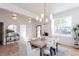 Dining room featuring a modern chandelier, light walls, and hardwood floors at 3395 Lee St, East Point, GA 30344