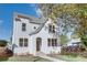 Charming white brick two-story home with landscaped front yard and black framed windows at 3395 Lee St, East Point, GA 30344