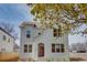 Charming white brick two-story home with landscaped front yard and black framed windows at 3395 Lee St, East Point, GA 30344