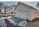 A white garage with an attached house, set on a partially snow covered lot at 3395 Lee St, East Point, GA 30344