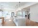 Open-concept kitchen with white countertops, center island, and clear view of the coffered-ceiling living room at 3395 Lee St, East Point, GA 30344