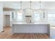 Bright kitchen featuring stainless steel appliances and a large center island with waterfall countertop at 3395 Lee St, East Point, GA 30344