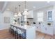 Modern kitchen with large island, pendant lights, and white cabinetry at 3395 Lee St, East Point, GA 30344